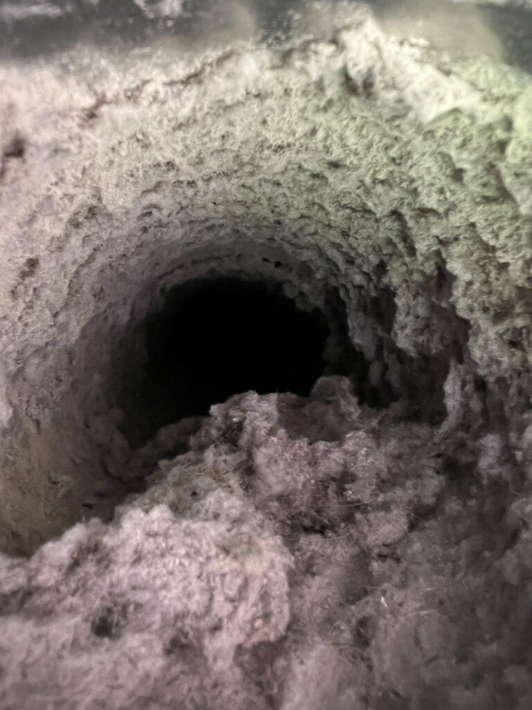 A dirty dryer vent before a dryer vent cleaning in Woodbury, Mn
