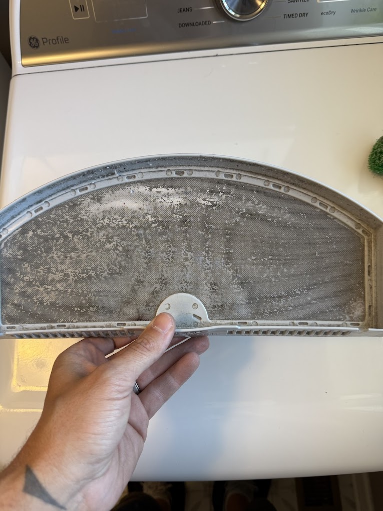 A Dirty Lint Trap filled with fabric softener residue